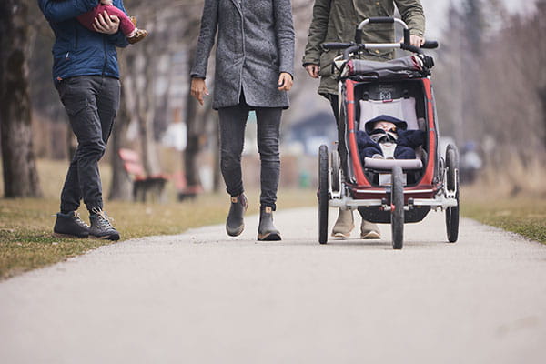 barfuß stiefel im einsatz von eltern, die ihren kinderwagen schieben